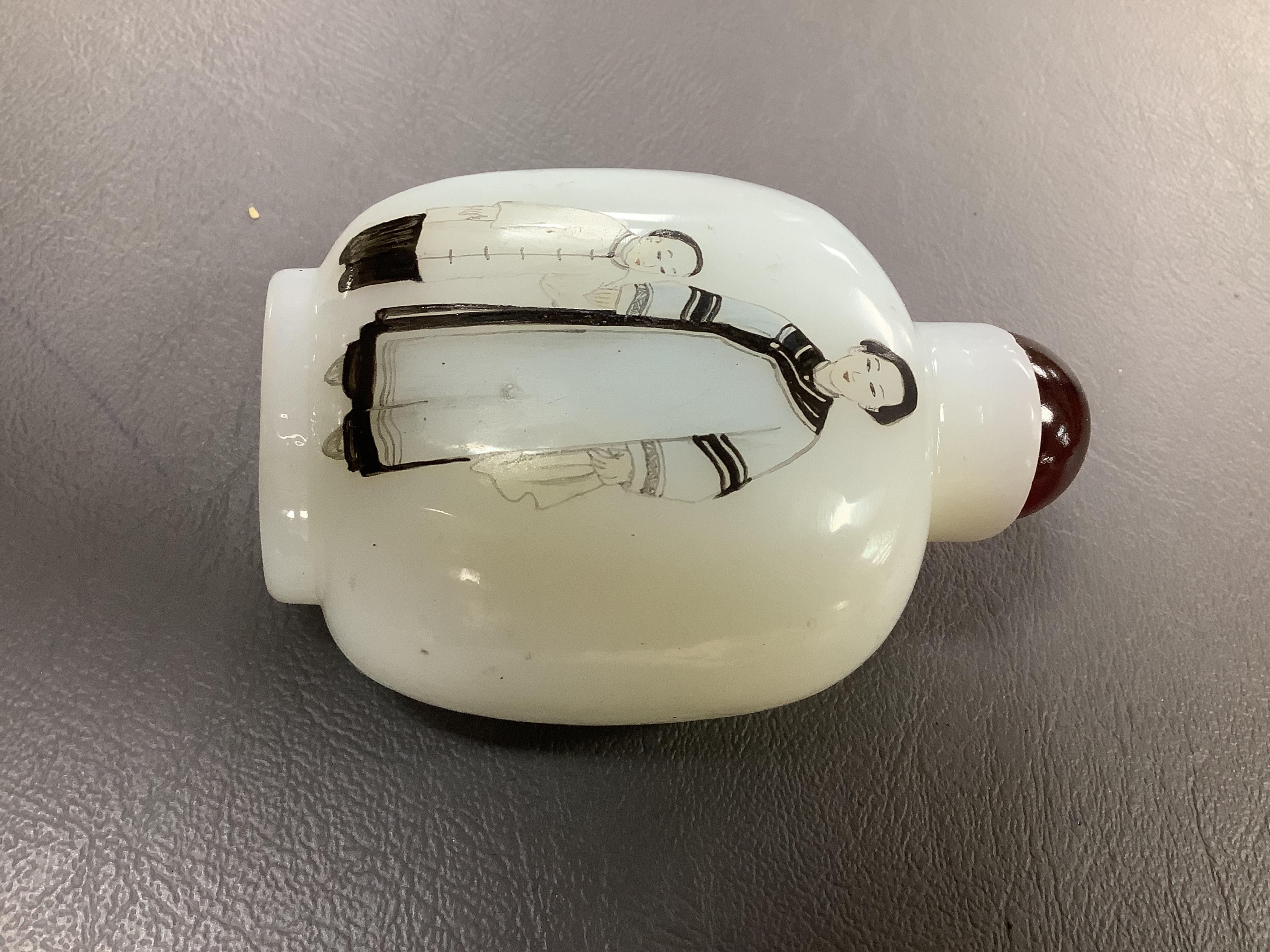 A Chinese enamelled white glass snuff bottle, a blue and white bird feeder and a famille rose vase, the first 9cm